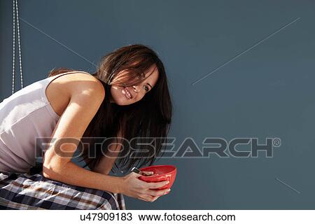 Smiling woman eating bowl of cereal View Large Photo Image Stock Image - Smiling woman eating bowl of cereal. Fotosearch