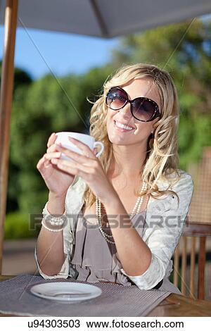 Smiling woman having cup of coffee View Large Photo Image Stock Image - Smiling woman having cup of coffee. Fotosearch