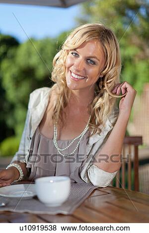 Smiling woman having cup of coffee View Large Photo Image Stock Photo - Smiling woman having cup of coffee. Fotosearch