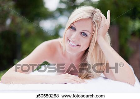 Smiling woman having massage outdoors View Large Photo Image Stock Photo - Smiling woman having massage outdoors. Fotosearch