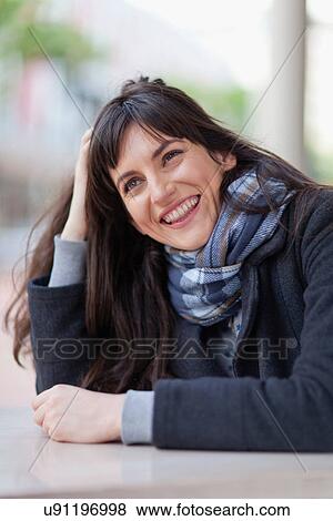 Smiling woman sitting in cafe View Large Photo Image Stock Photo - Smiling woman sitting in cafe. Fotosearch