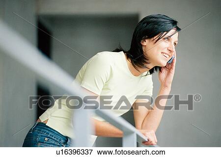 Stock Photo - Smiling woman talking on cell phone. Fotosearch