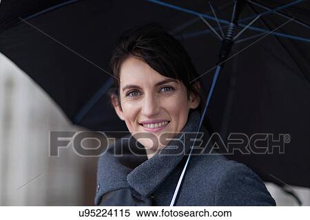 Smiling woman under umbrella View Large Photo Image Stock Photography - Smiling woman under umbrella. Fotosearch