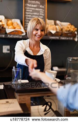 Smiling woman working in cafe View Large Photo Image Picture - Smiling woman working in cafe. Fotosearch