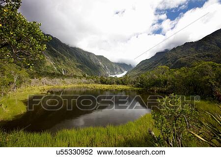 Still lake in rural landscape View Large Photo Image Stock Image - Still lake in rural landscape. Fotosearch