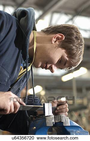 Stock Image - Student at work in shop class. Fotosearch