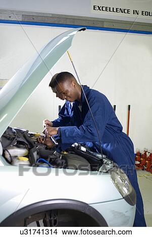 Student working on car engine View Large Photo Image Picture - Student working on car engine. Fotosearch