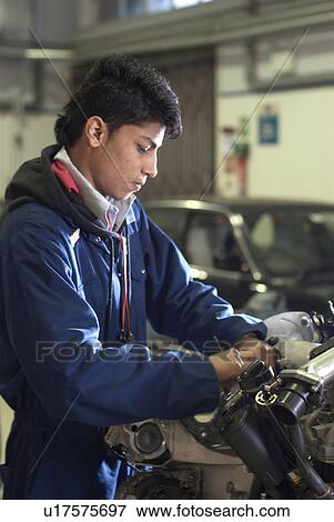 Stock Photo - Student working on car engine. Fotosearch