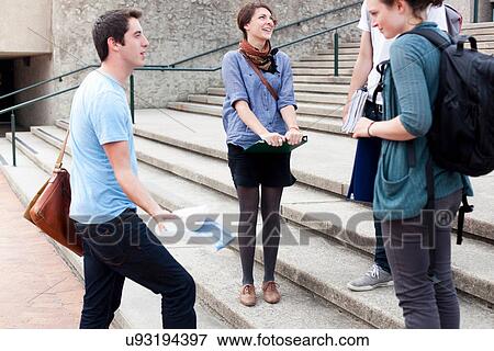 Stock Photo - Students talking on campus steps. Fotosearch