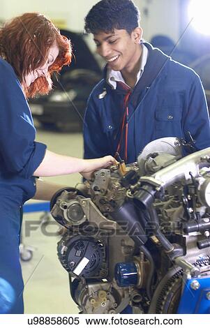 Stock Photography - Students working on car engine. Fotosearch