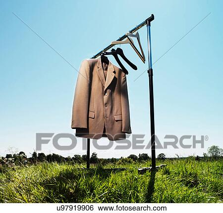 Suit jacket hanging in field View Large Photo Image Stock Photograph - Suit jacket hanging in field. Fotosearch