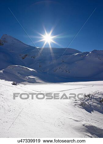 Sun shining over snowy landscape View Large Photo Image Stock Photo - Sun shining over snowy landscape. Fotosearch