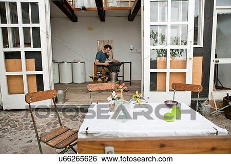 Table and chairs in artist's courtyard View Large Photo Image Stock Photograph - Table and chairs in artist's courtyard. Fotosearch