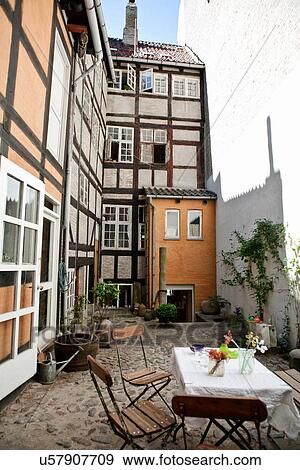 Stock Photo - Table and chairs in courtyard. Fotosearch