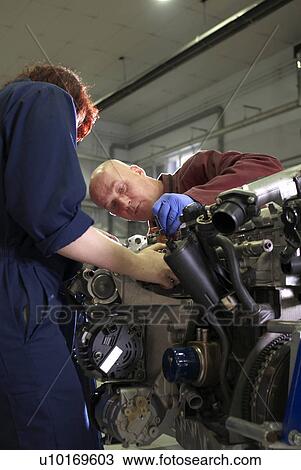 Teacher helping student with car engine View Large Photo Image Stock Image - Teacher helping student with car engine. Fotosearch