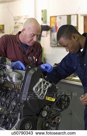 Teacher helping student with car engine View Large Photo Image Stock Image - Teacher helping student with car engine. Fotosearch