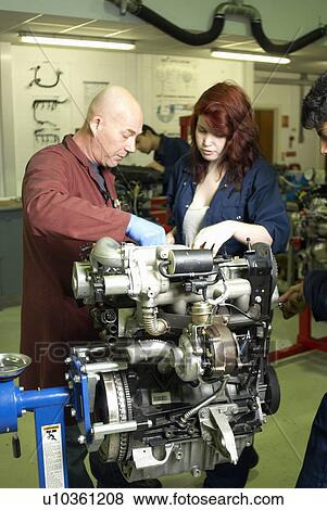 Stock Photo - Teacher helping student with car engine. Fotosearch