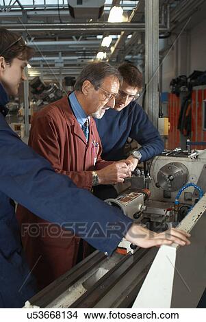 Teacher helping students in shop class View Large Photo Image Picture - Teacher helping students in shop class. Fotosearch