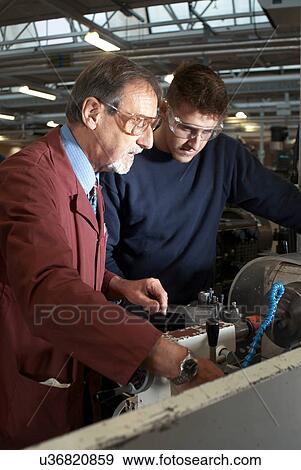 Teacher helping students in shop class View Large Photo Image Stock Photo - Teacher helping students in shop class. Fotosearch
