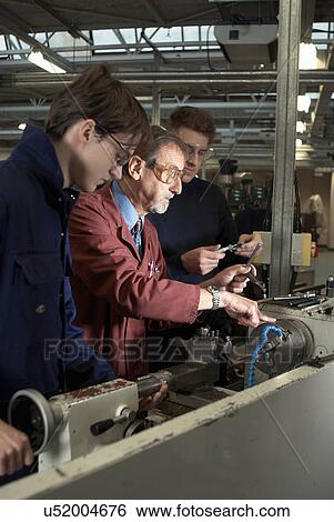 Teacher helping students in shop class View Large Photo Image Stock Photograph - Teacher helping students in shop class. Fotosearch