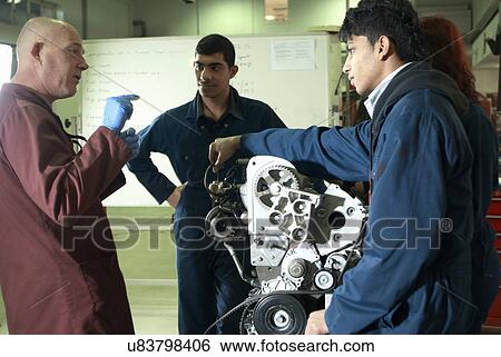 Teacher helping students with car engine View Large Photo Image Stock Photograph - Teacher helping students with car engine. Fotosearch