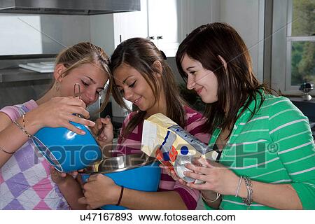 Stock Image - Teen girls cooking. Fotosearch
