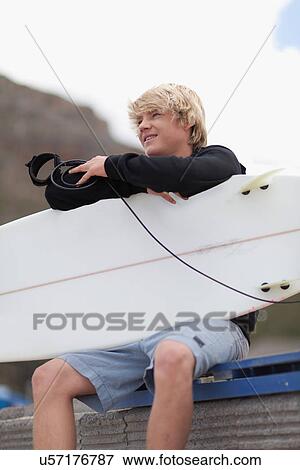 Teenage boy with surfboard on beach View Large Photo Image Stock Photo - Teenage boy with surfboard on beach. Fotosearch
