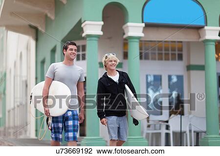 Teenage boys carrying surfboards View Large Photo Image Stock Image - Teenage boys carrying surfboards. Fotosearch