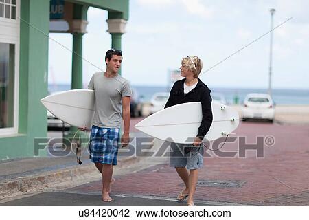 Teenage boys carrying surfboards View Large Photo Image Stock Image - Teenage boys carrying surfboards. Fotosearch