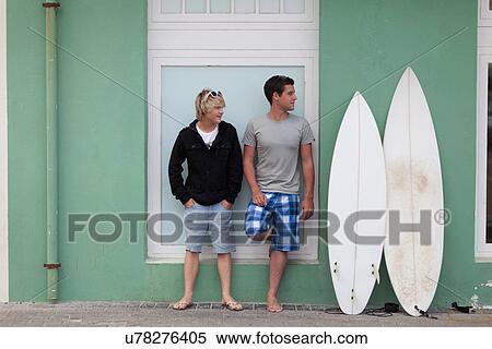 Teenage boys standing with surfboards View Large Photo Image Stock Photography - Teenage boys standing with surfboards. Fotosearch