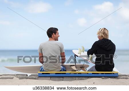 Picture - Teenage boys with surfboards on beach. Fotosearch