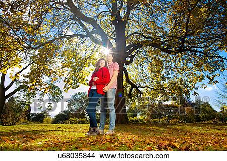 Picture - Teenage couple hugging in park. Fotosearch