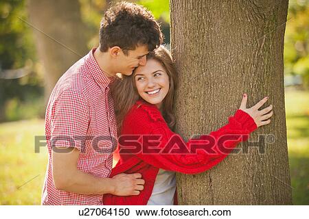 Teenage couple hugging in park View Large Photo Image Stock Image - Teenage couple hugging in park. Fotosearch
