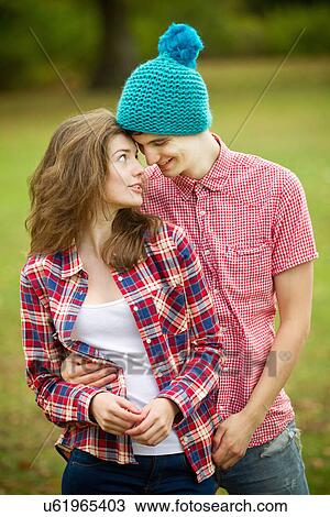 Teenage couple hugging in park View Large Photo Image Stock Image - Teenage couple hugging in park. Fotosearch