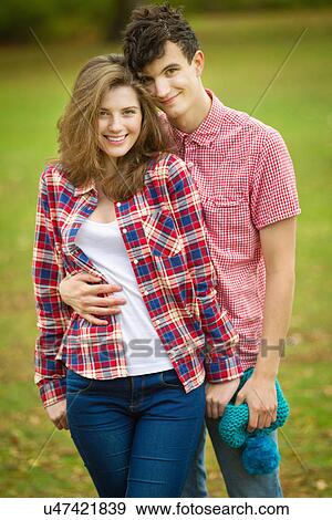 Stock Photo - Teenage couple hugging in park. Fotosearch