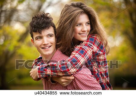 Teenage couple hugging in park View Large Photo Image Stock Photography - Teenage couple hugging in park. Fotosearch