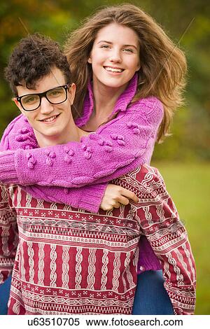 Stock Photography - Teenage couple hugging in park. Fotosearch