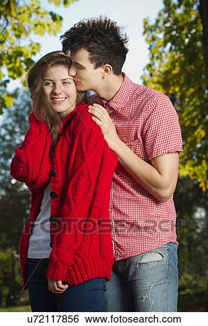 Teenage couple kissing in park View Large Photo Image Stock Photograph - Teenage couple kissing in park. Fotosearch