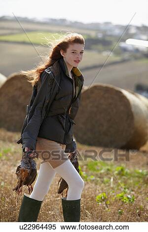 Stock Photography - Teenage girl carrying game birds. Fotosearch