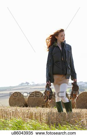 Teenage girl carrying game birds View Large Photo Image Stock Photography - Teenage girl carrying game birds. Fotosearch