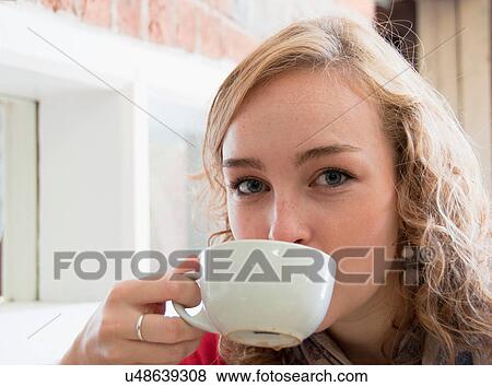 Stock Photo - Teenage girl drinking cup of coffee. Fotosearch