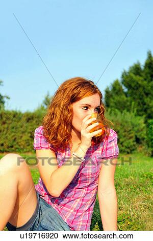 Teenage girl drinking juice in backyard View Large Photo Image Stock Image - Teenage girl drinking juice in backyard. Fotosearch