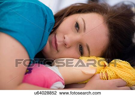 Teenage girl hugging rag doll View Large Photo Image Stock Image - Teenage girl hugging rag doll. Fotosearch