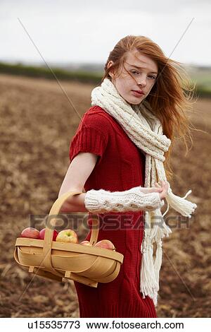 Teenage girl picking apples in field View Large Photo Image Stock Image - Teenage girl picking apples in field. Fotosearch