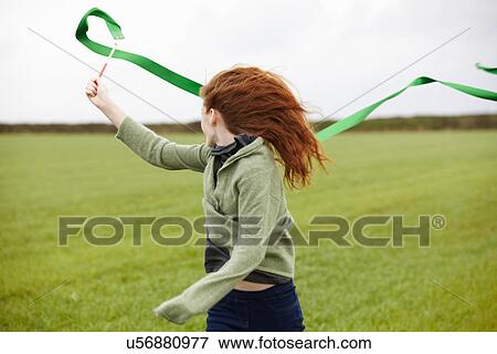 Teenage girl playing with ribbon View Large Photo Image Stock Photo - Teenage girl playing with ribbon. Fotosearch