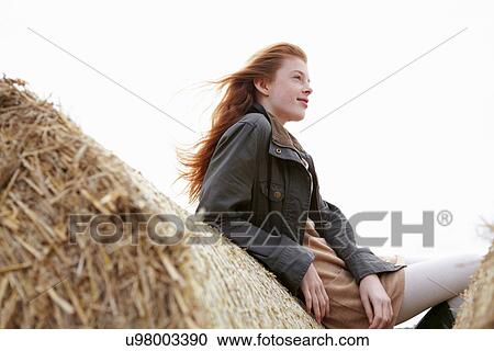 Teenage girl resting on haybales View Large Photo Image Stock Image - Teenage girl resting on haybales. Fotosearch