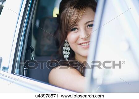 Stock Image - Teenage girl smiling in car. Fotosearch