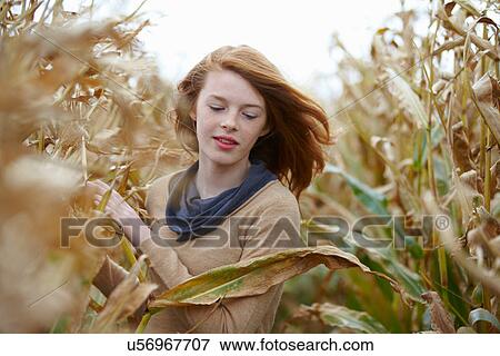 Teenage girl walking in cornfield View Large Photo Image Stock Photo - Teenage girl walking in cornfield. Fotosearch