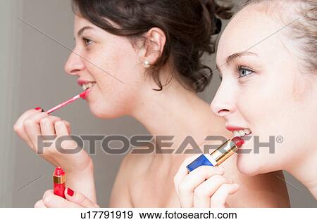 Teenage girls applying makeup View Large Photo Image Stock Photo - Teenage girls applying makeup. Fotosearch