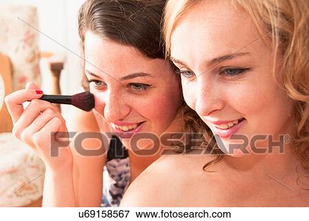 Stock Photo - Teenage girls applying makeup. Fotosearch